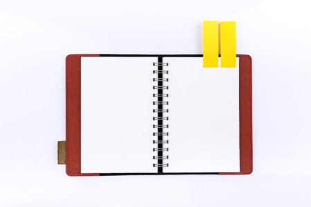 Open notebook with sticknote  on white backgroundの写真素材