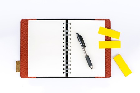Open notebook with sticknote  and pen on white backgroundの写真素材