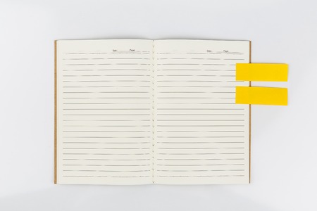 Open notebook with sticknote  on white backgroundの写真素材