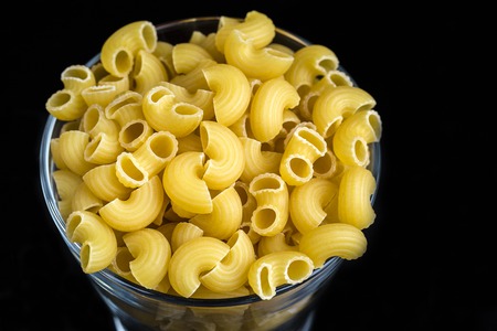 Macaroni in the grass on black backgroundの写真素材