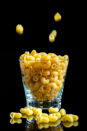Macaroni in the grass on black background