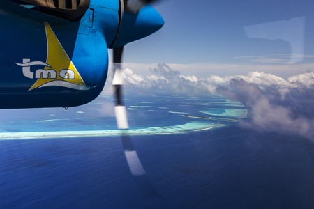 Indien Ocean Malddives - June 14, 2015 : Seaplane taxi fly over Atolls in Indien Ocean To transfer passengers to the hotel in the islands.のeditorial素材