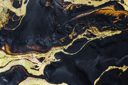 Texture of Crude oil spill on sand beach from oil spill accidentの写真素材