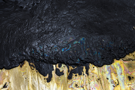 Texture of Crude oil spill on sand beach from oil spill accidentの写真素材