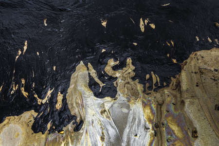Texture of Crude oil spill on sand beach from oil spill accidentの写真素材