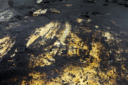 Texture of Crude oil spill on sand beach from oil spill accidentの写真素材