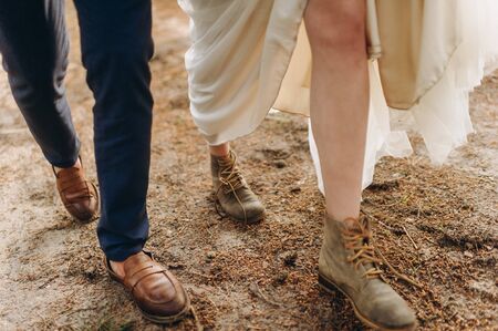 A young couple of brides walking in the pine forestの写真素材