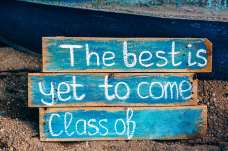 Old wooden board with chalk inscription the best is yet to come. School theme.の写真素材