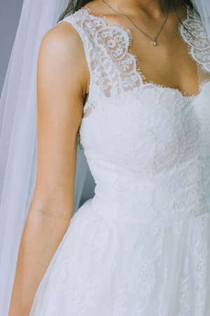 Details of a wedding dress. Close up of faceless girl in beautiful white wedding dress.の写真素材