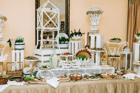 Beautifully decorated catering banquet table with different food snacks and appetizers.の写真素材