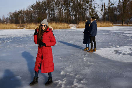 Young friends having fun outdoors in winter time. Concept of friendship and funの写真素材
