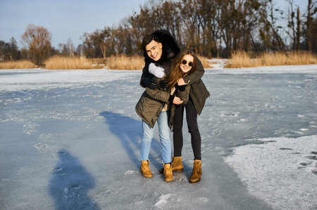 happy couple hugging and laughing outdoors in winter