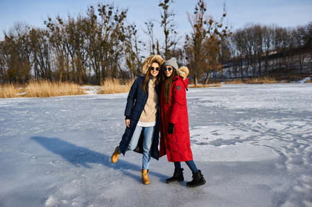 A trendy young girls walk and have a fun outdoor in winterの写真素材