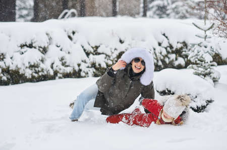 A young mother with her children have a fun and playing outdoor near the homeの写真素材