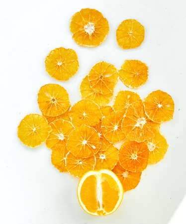 Flat lay composition with fresh and dried orange slices on white background.の写真素材