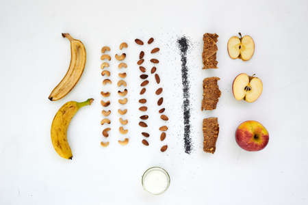 Flat lay of various dried and fresh fruits on a white background. Fruits, pastilles and fruit chips in creative background.の写真素材