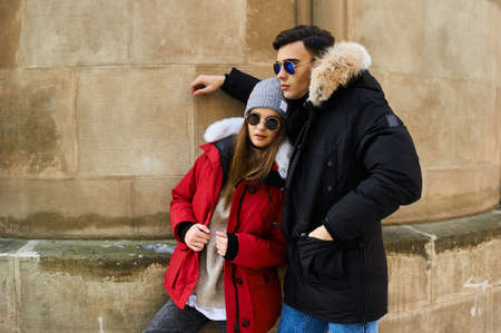 A trendy young couple walks in the city at christmastimeの写真素材