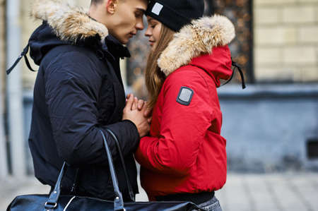 A trendy young couple walks in the city at christmastimeの写真素材