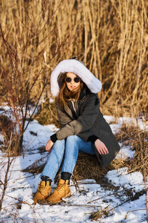 Portrait of happy young woman have a fun at beautiful sunny winter dayの写真素材