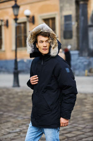 Portrait of a young handsome boy in the winter in the streetの写真素材