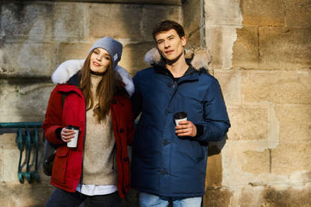 A trendy young couple walks in the city at christmastimeの写真素材