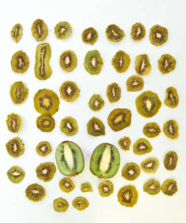 Fresh kiwi and dried kiwi slices on white background.の写真素材