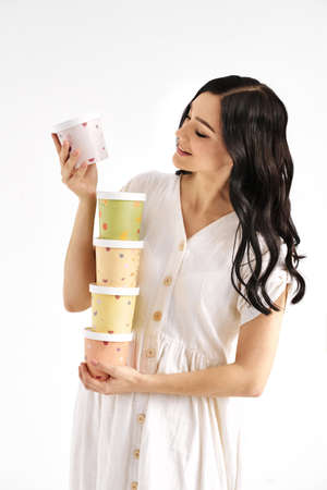 Girl holding a tower of colored paper boxes. People lifestyle concept.の写真素材