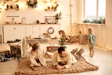 Young family dad, mom and their little son have a fun playing and cooking in the kitchenの写真素材