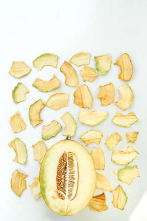 Flat lay composition with fresh and dried melon slices on white background. Top view.の写真素材