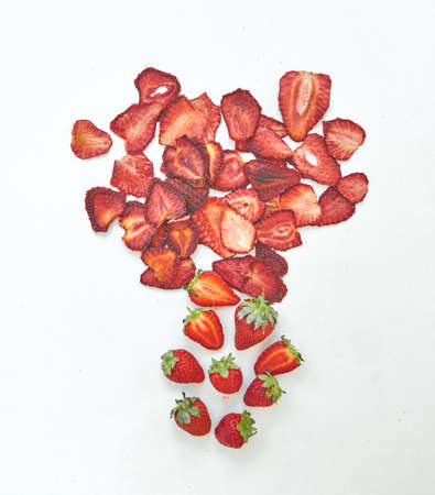 Flat lay composition with fresh and dried strawberries slices on white background.の写真素材