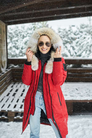 A portrait of beautiful caucasian girl in glases outdoor in snowy winterの写真素材