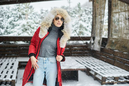 A portrait of beautiful caucasian girl in glases outdoor in snowy winterの写真素材
