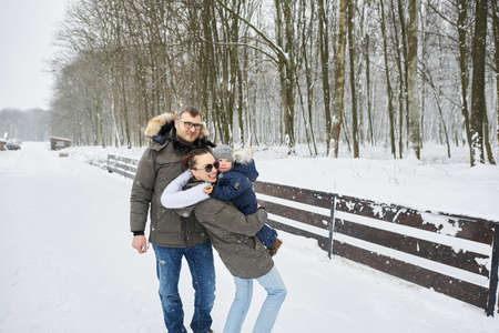 Happy family have a fun outside near the house in winterの写真素材