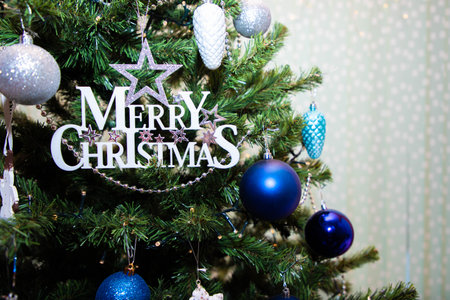 Christmas card with inscription Merry Christmass on christmas tree with toys.Copy space.Close up. High quality photoの写真素材