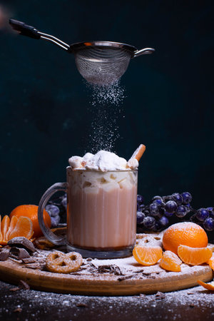 A mug of hot chocolate with cream and cinnamon stick marshmallow