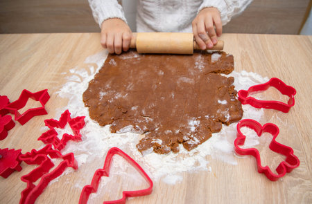 Gingerbread dough for Christmas cookies and cookie cutters.