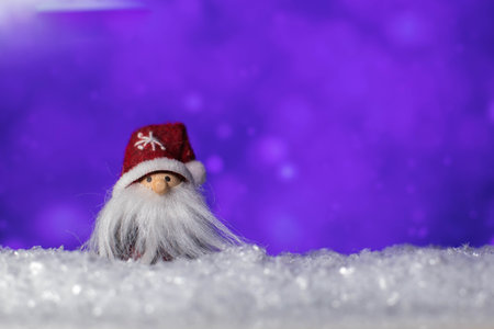 Gnome figurine with big beard standing on snowの写真素材