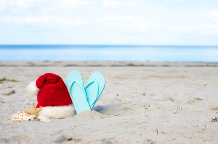 Santa Claus hat on the beach with starfish,beach slippersの写真素材