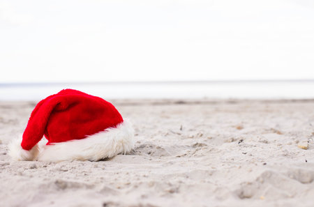 Santa Claus hat on the beach with starfish and cocktailの写真素材