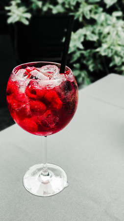 Tropical cooling cocktail with raspberries and with ice