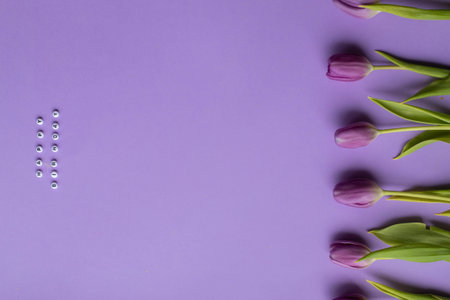 Spring tulip and text Happy Birhday on english laid out of multi-colored cube on violet backgroundの写真素材