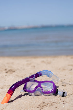 childrens diving mask on the sand at the beachの写真素材