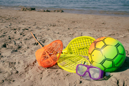 Beach tennis racket and ball, swimming mask ,and beach playing ball on tne beachの写真素材
