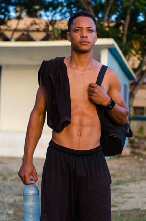 Latino boy model in day sports session shirtless and drink waterの写真素材