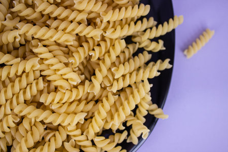 Dry pasta in the form of spirals close-up.