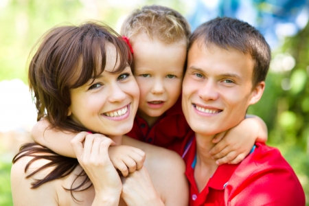 Young cheerful family outdoorsの写真素材