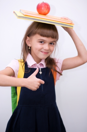 Cute girl is holding book - school conceptの写真素材