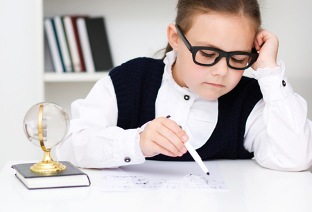 Cute girl is reading book - school, education conceptの写真素材