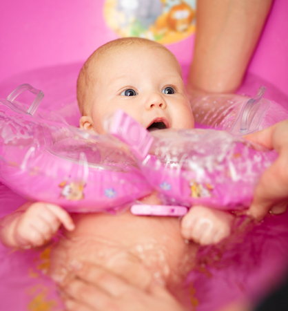 Cute baby girl enjoying bathの写真素材