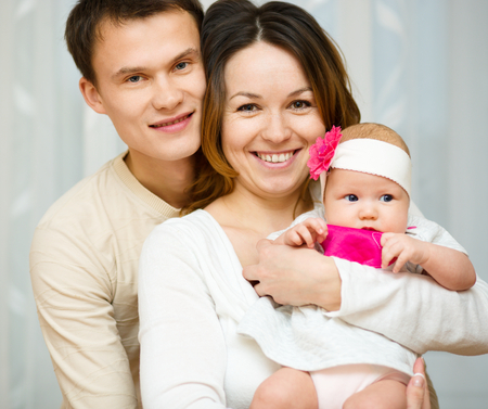 Mother and father holds cute 3 months babyの写真素材